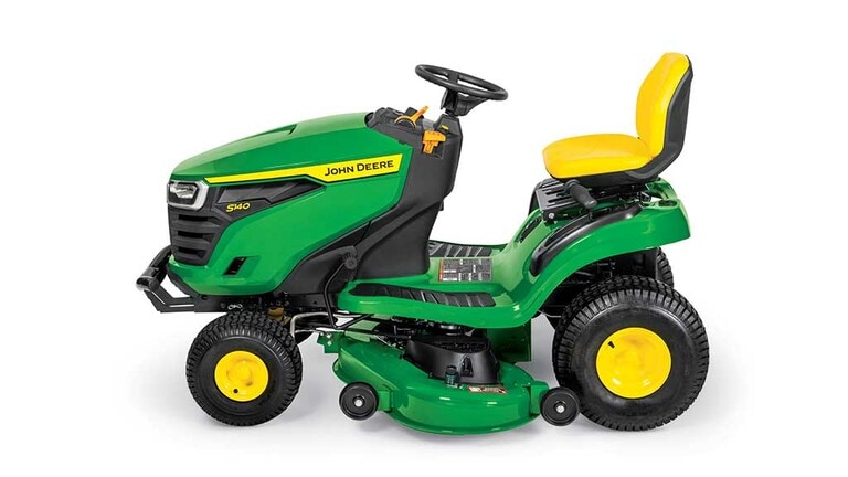 A left-facing green riding mower with a yellow seat and green mowing deck on a white background. (4th thumbnail)