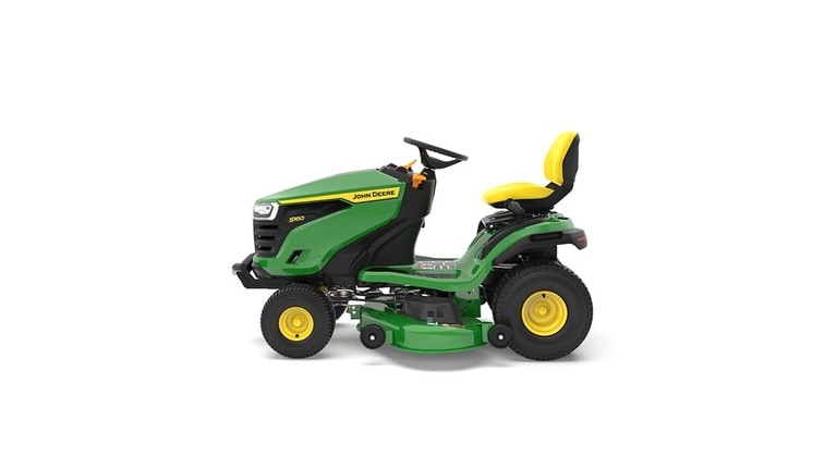 A left-facing green riding mower with a yellow seat and green mowing deck on a white background. (4th thumbnail)