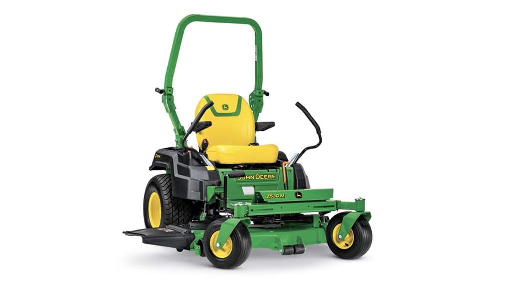 A front-right studio shot of a green zero-turn mower with a yellow seat on a white background.