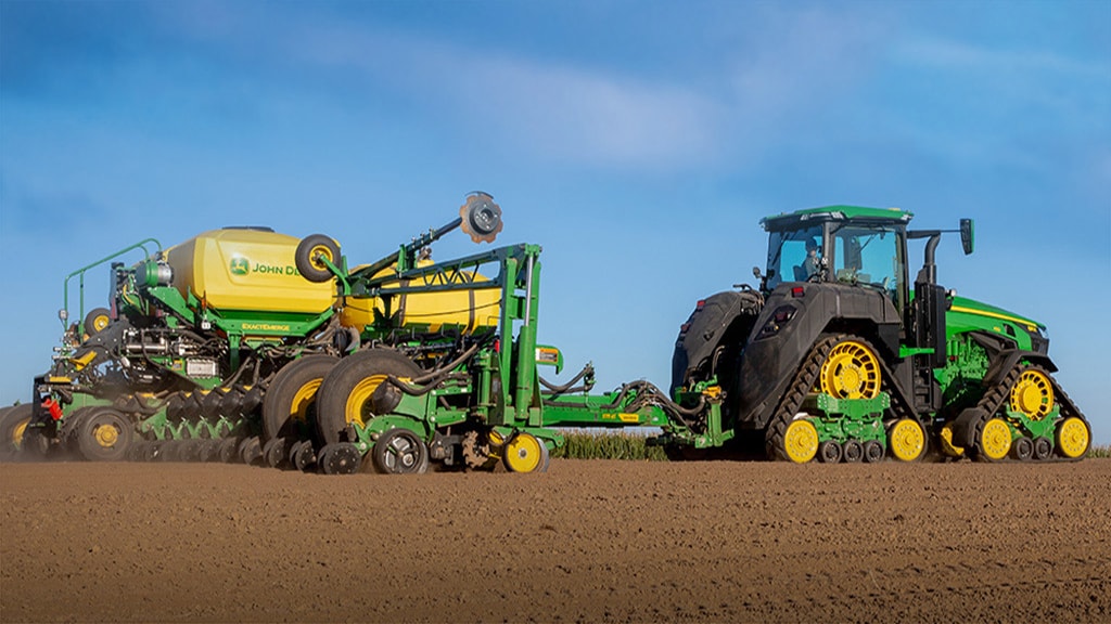 8 Series Tractor with drawn planter in field