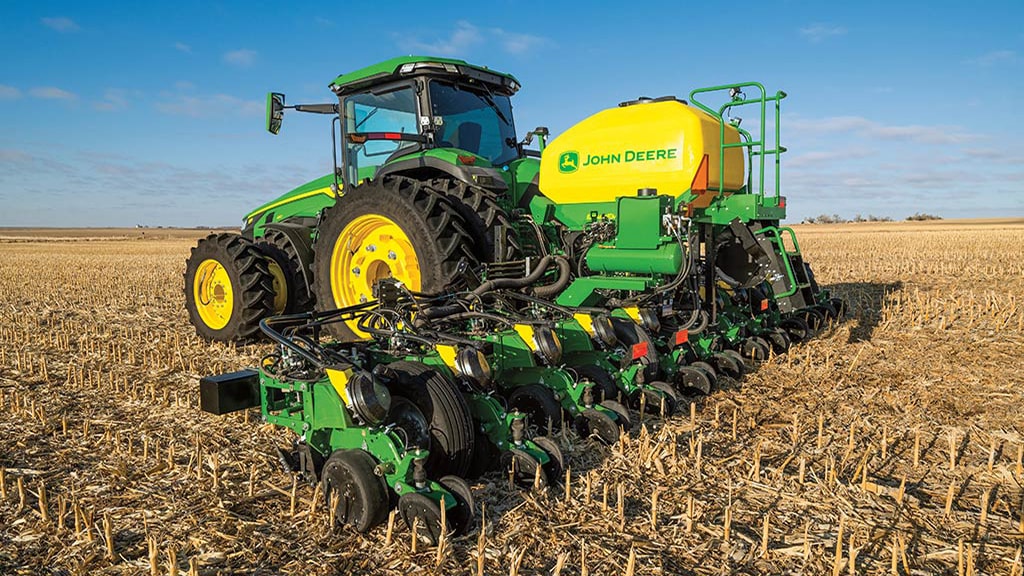 8 Series Tractor with mounted planter in field