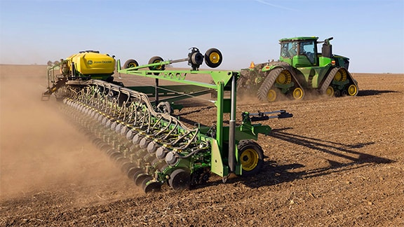 9RX Tractor with drawn DB planter working in field