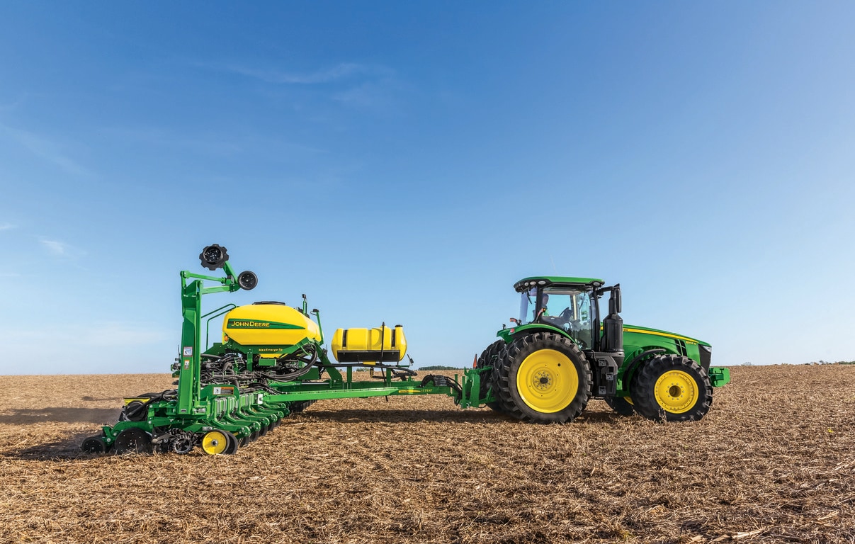 field shot of a 8345R tractor pulling a 1775NT MaxEmerge planter