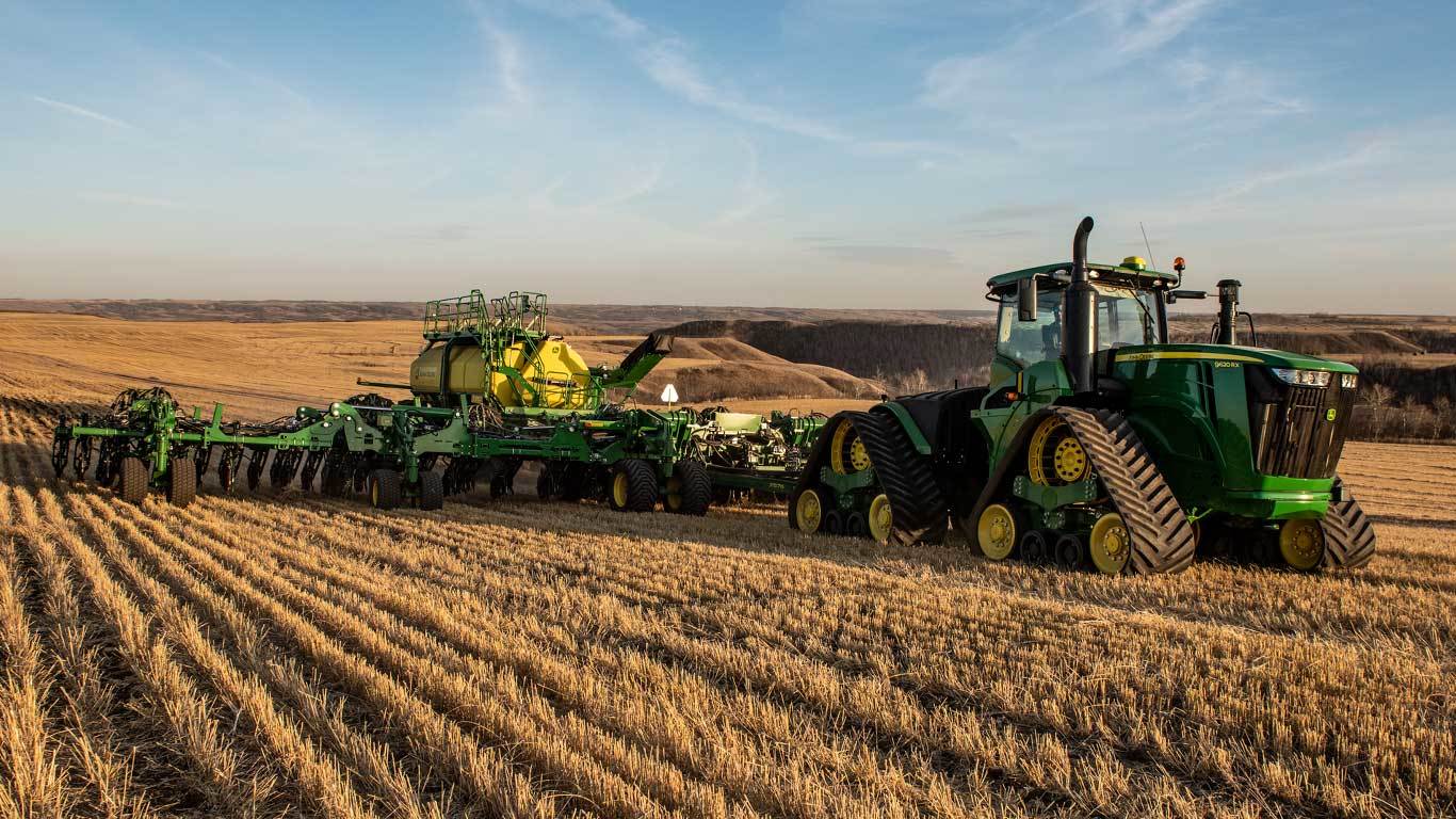 P576 Air Hoe Drill in a field behind a 4WD track tractor