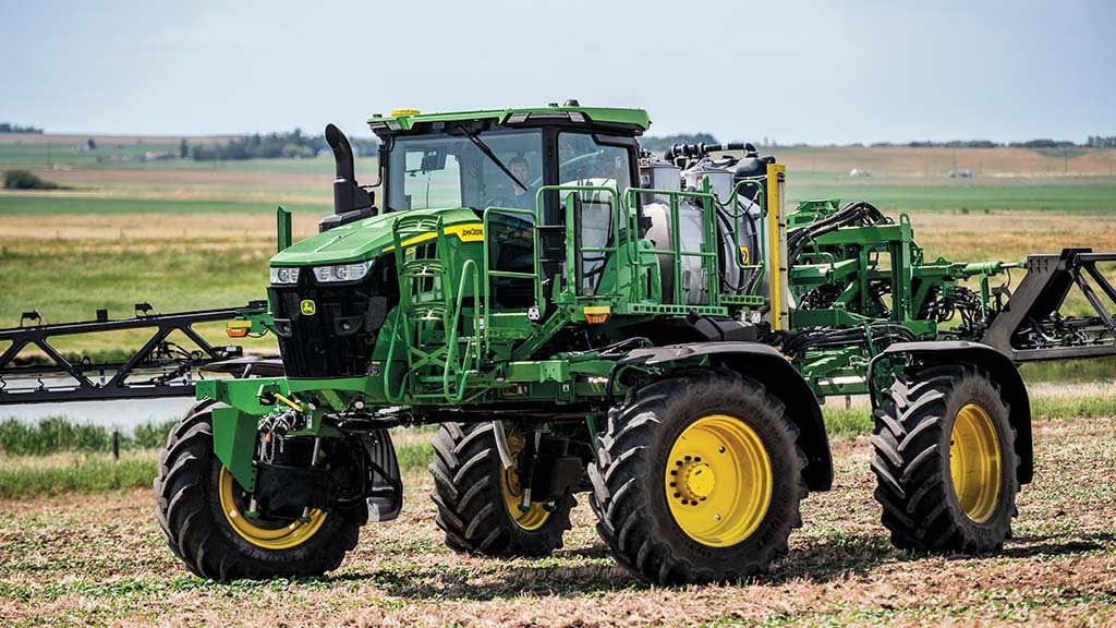 Self-propelled sprayer turning using four-wheel steer.