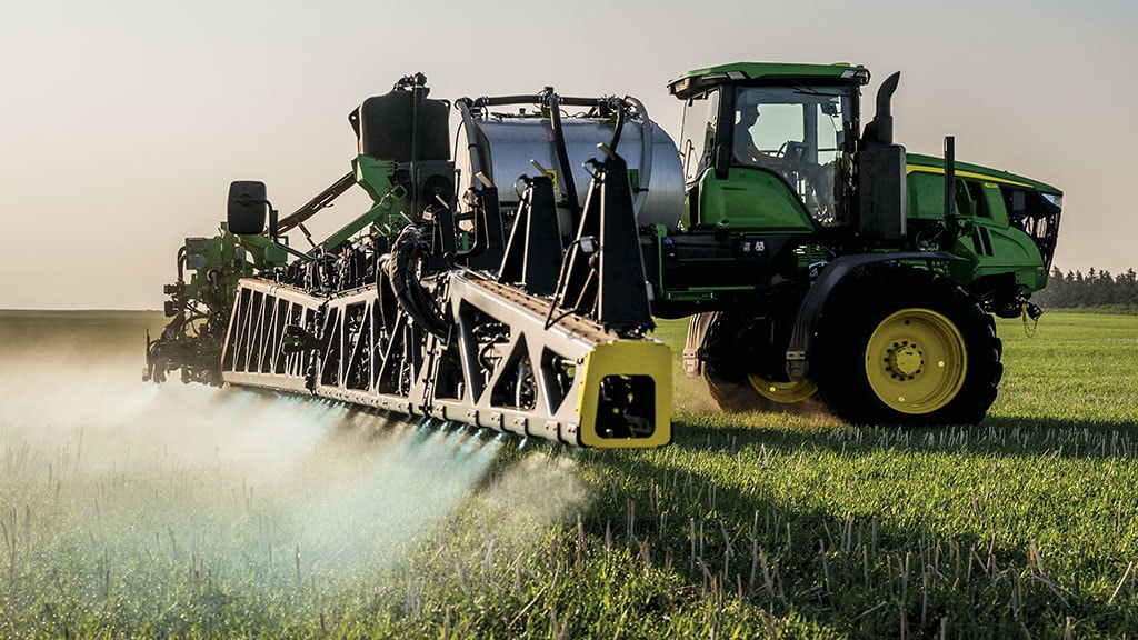 Self-propelled sprayer with dual-product tanks target spraying weeds.