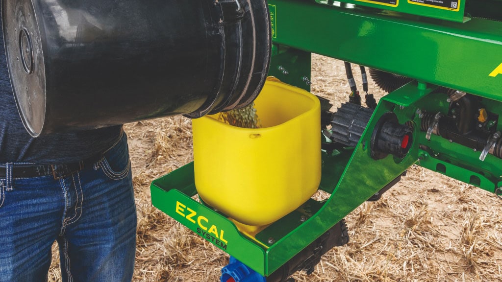 Close-up of a farmer loading seed into the EZCal System.