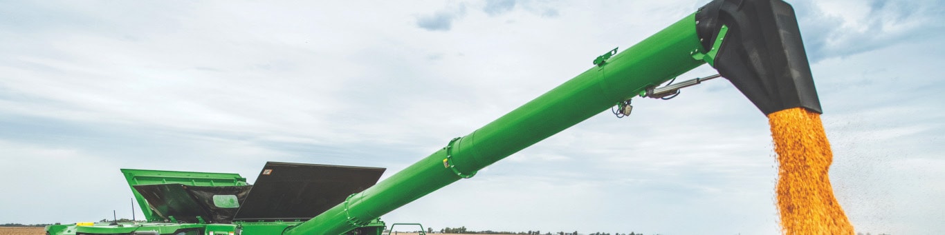 Auger with an adjustable spout unloading grain.