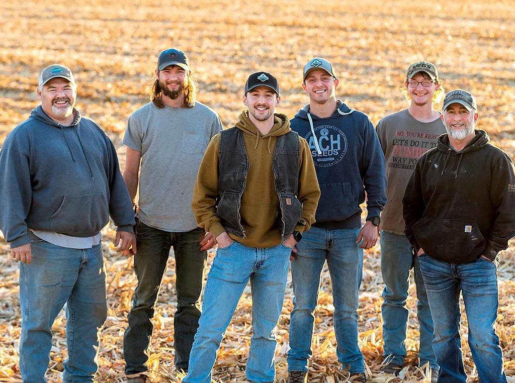 group of men standing in field smiling