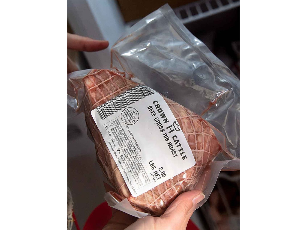 Beef rib roast in plastic vacuum packaging with label saying Crown H Cattle Beef Cross Rib Roast