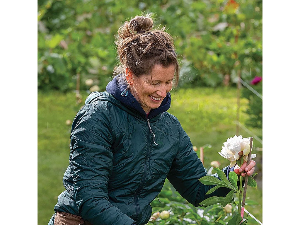 a farmer tending to a white flower 