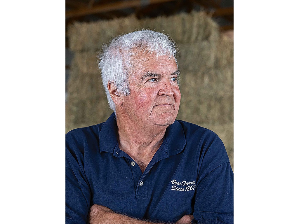 Iowa farmer Dan Vos looking off to the left with his arms crossed