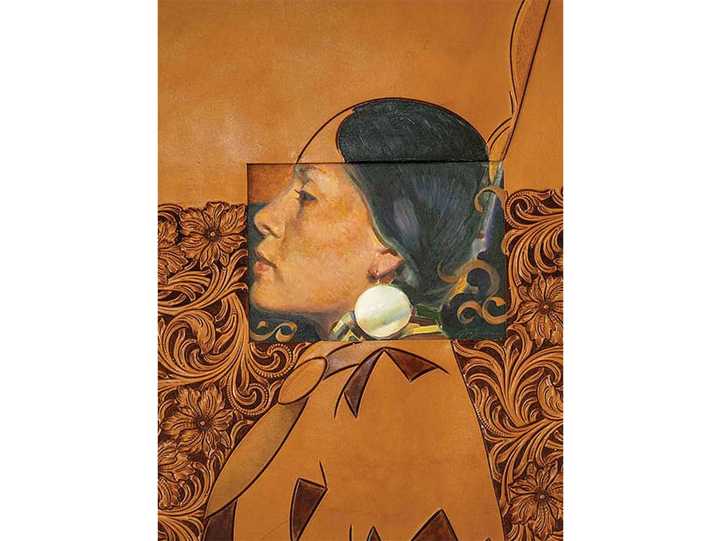 a leather carving of a Native American's profile