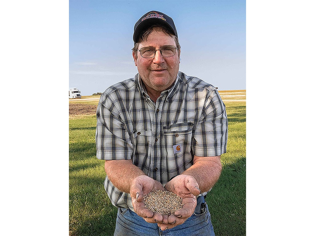 Tim Turek, holding Turkey Red wheat in both hands.