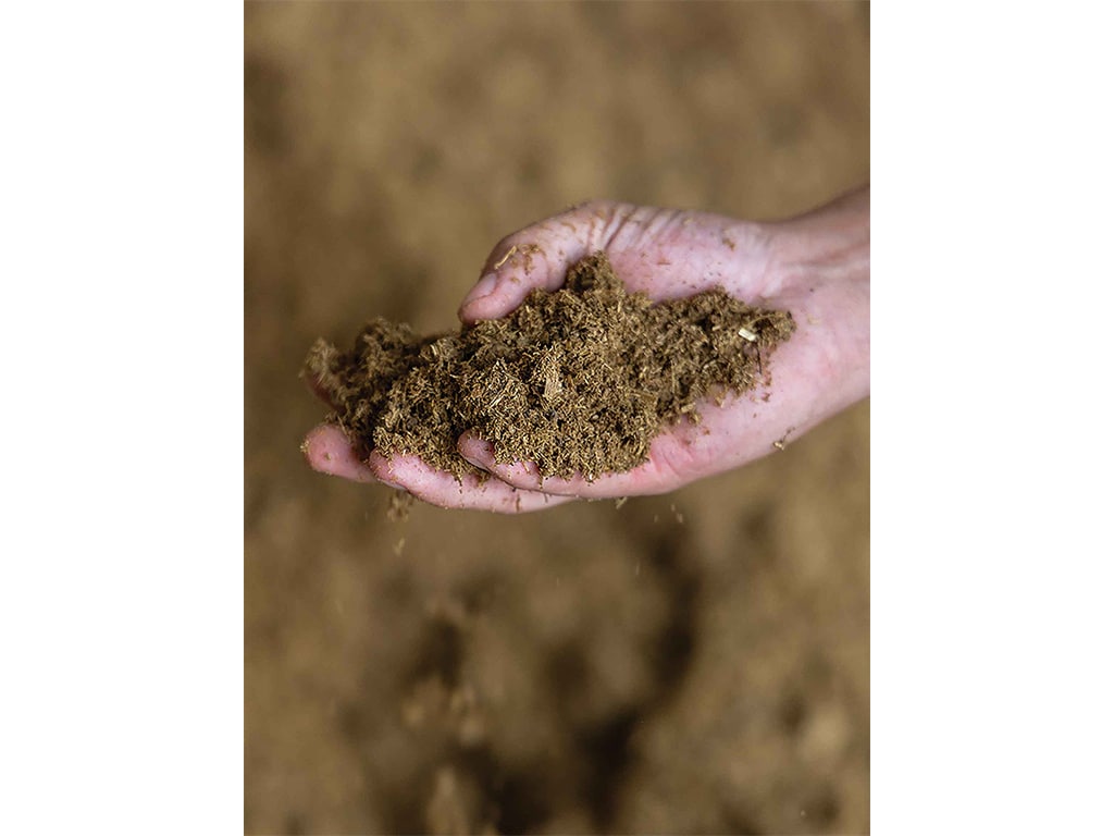 a close up of a hand holding fertilizer 