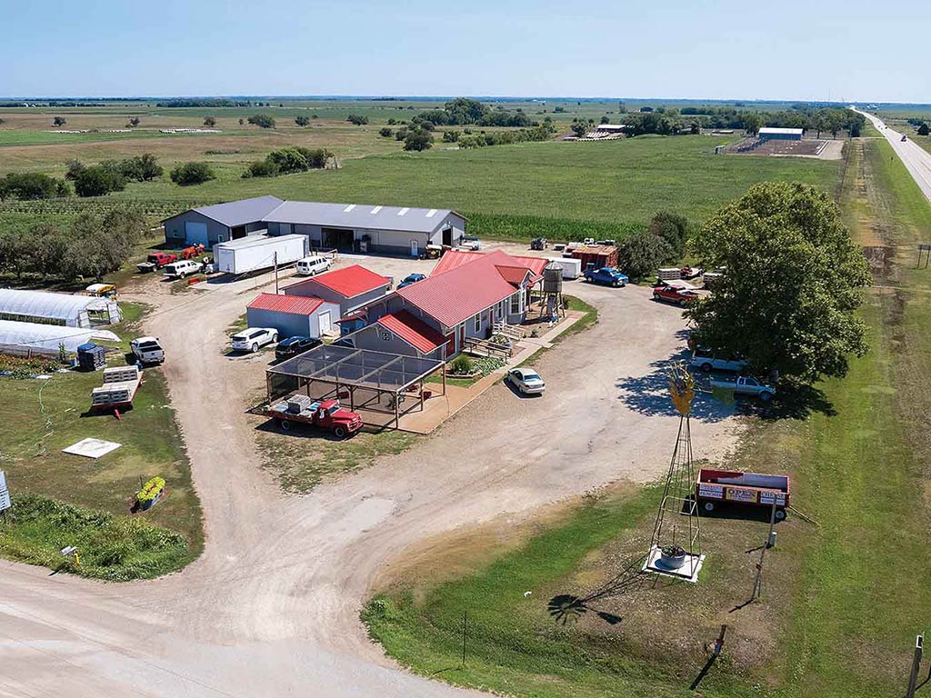 an aerial view of a farm facility and retail space