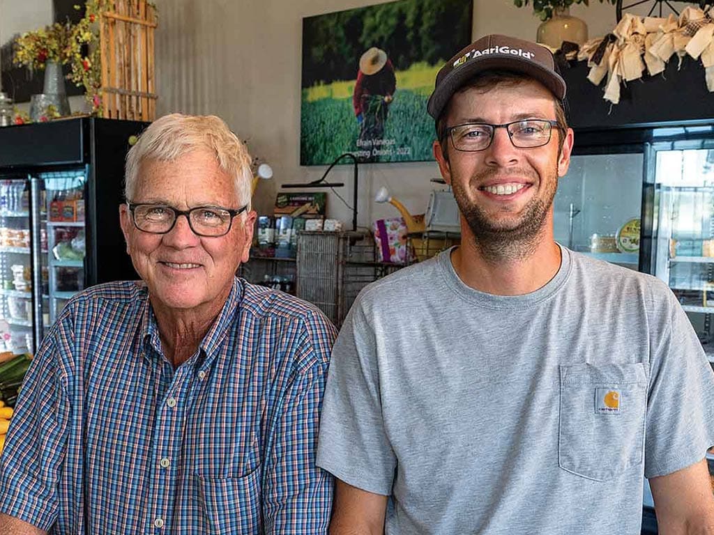 two smiling farmers in the retail shop