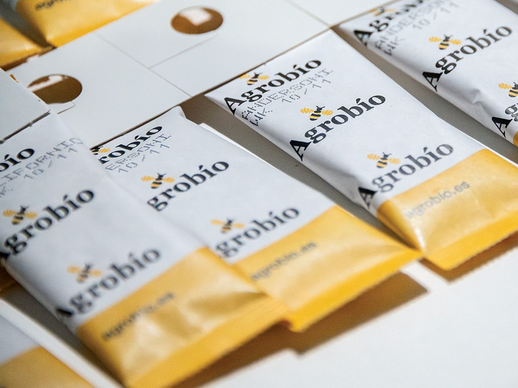 closeup of small yellow and white packets with the word Agrobio printed on them