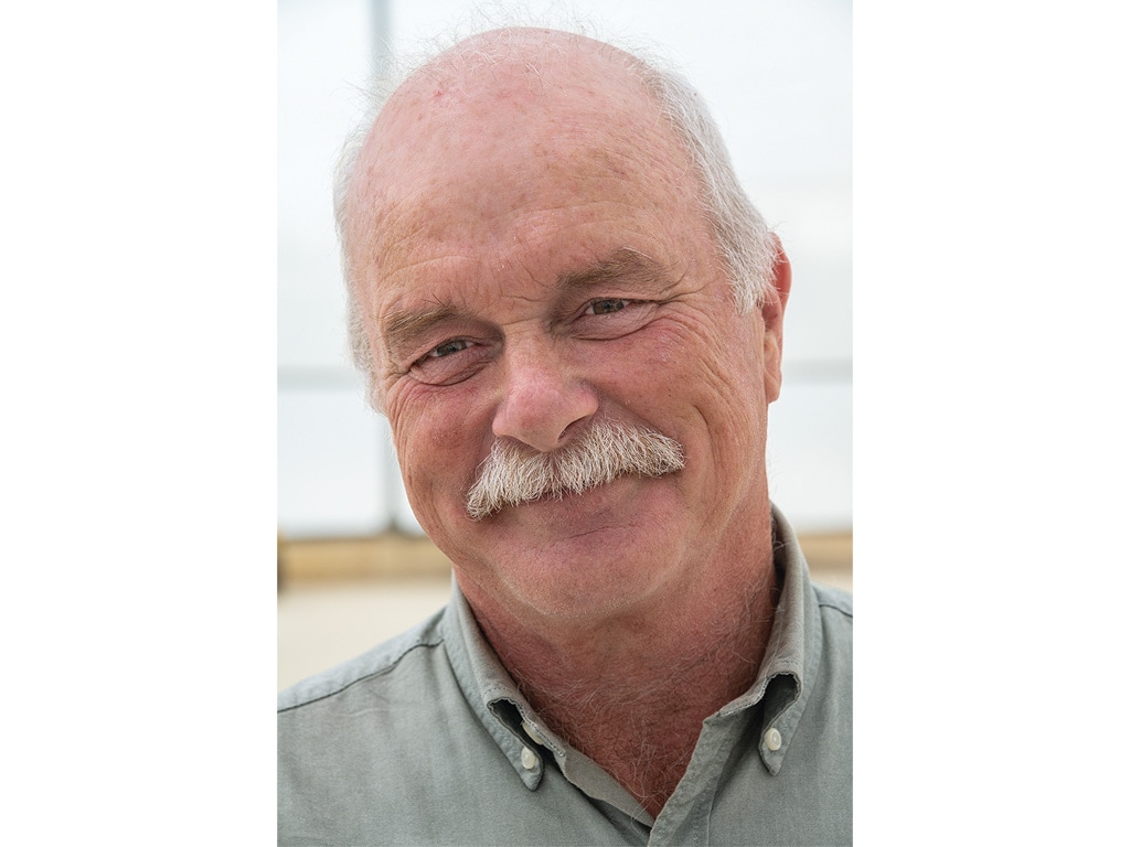 closeup of smiling person with white mustache