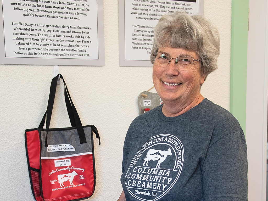 An employee wearing a sweatshirt that reads Columbia Community Creamery