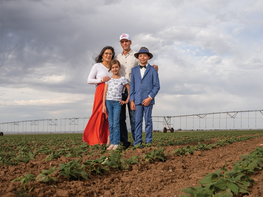 a family of four in a pinto bean field