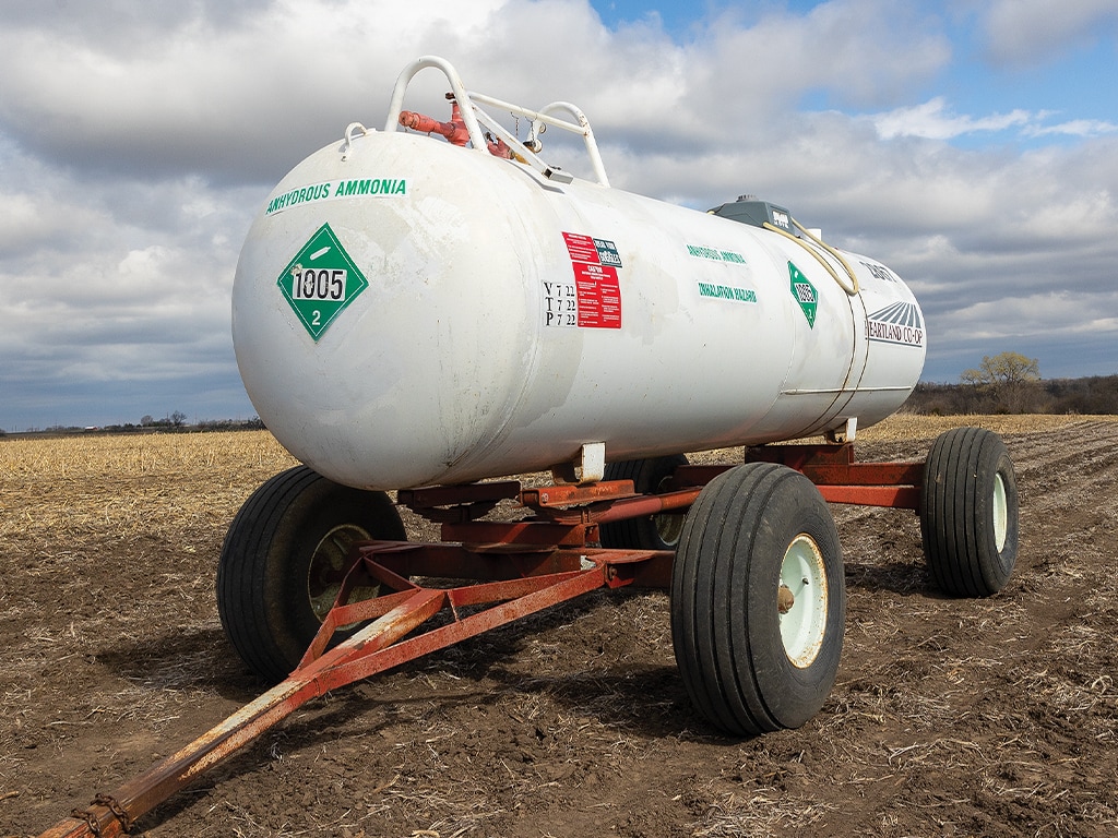 a tank of ammonia being pulled across a field