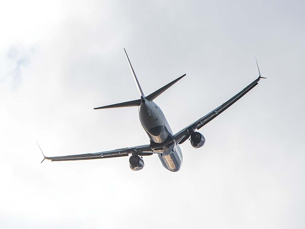 the underside view of a jet flying through the sky