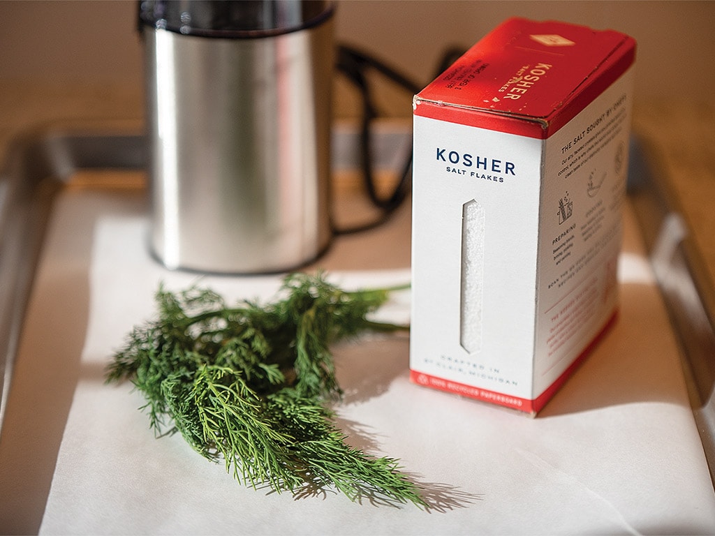 herbs and a box of salt in a steel tray