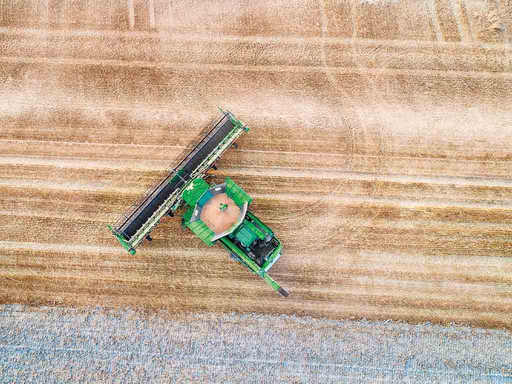 a Deere combine turning in a field using AutoTrac Turn Automation