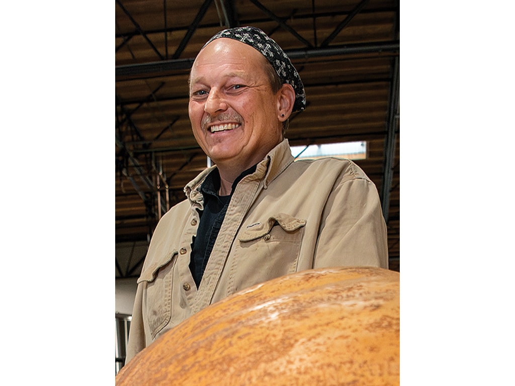 Kendall Spielman smiling above a pumpkin