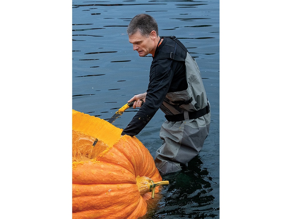 Gary Kristensen carves his pumpkin boat