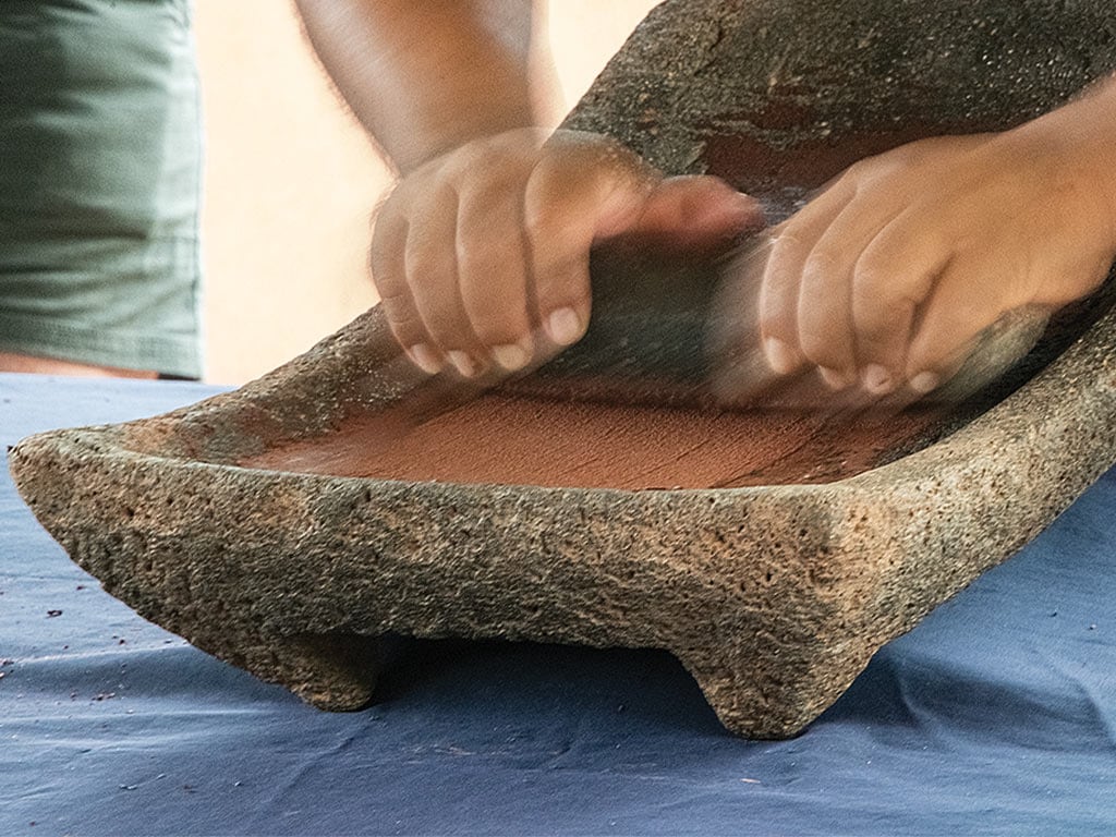 Cho demonstrates old-school cacao processing