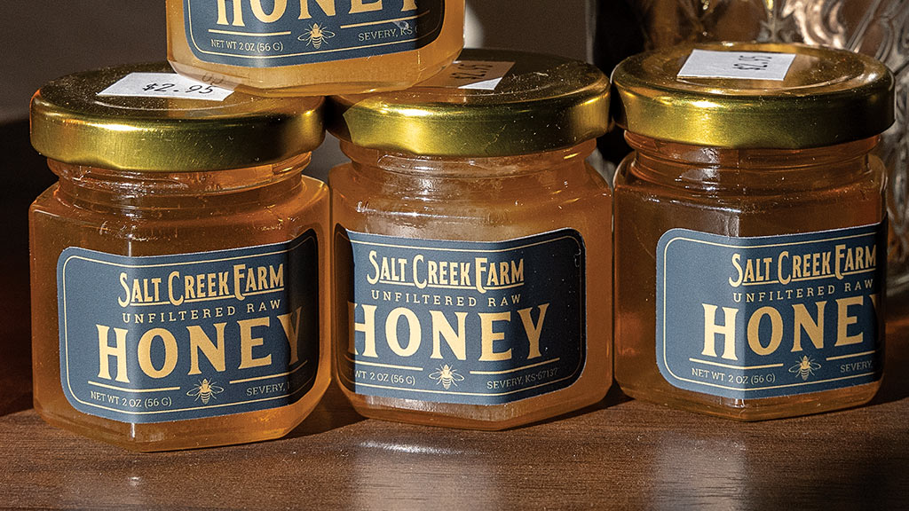 three bottles of honey displaying label honey
