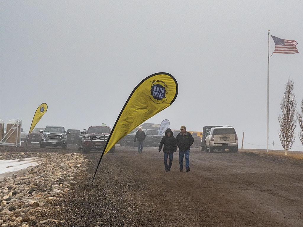 Couple seen walking on a freezing fog dirt road for a farm show