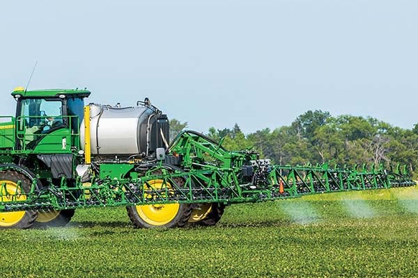 Cab tractor in a field using See & Spray Premium